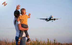 parent and child wave to airplane